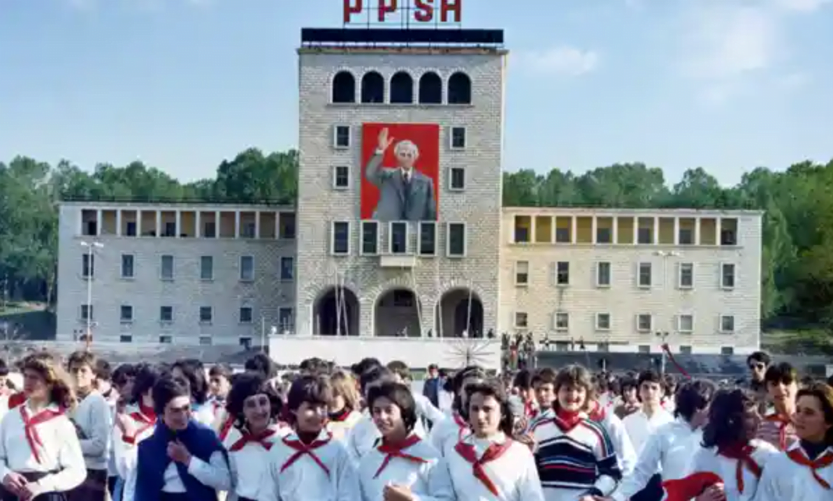 Girls in young pioneers uniforms walk down the Boulevard of the Heroes of the People in Tirana in 1987. In the background, adorned with a picture of the late party chief Enver Hoxha, is the city’s university. Photograph: Rudi Blaha/AP